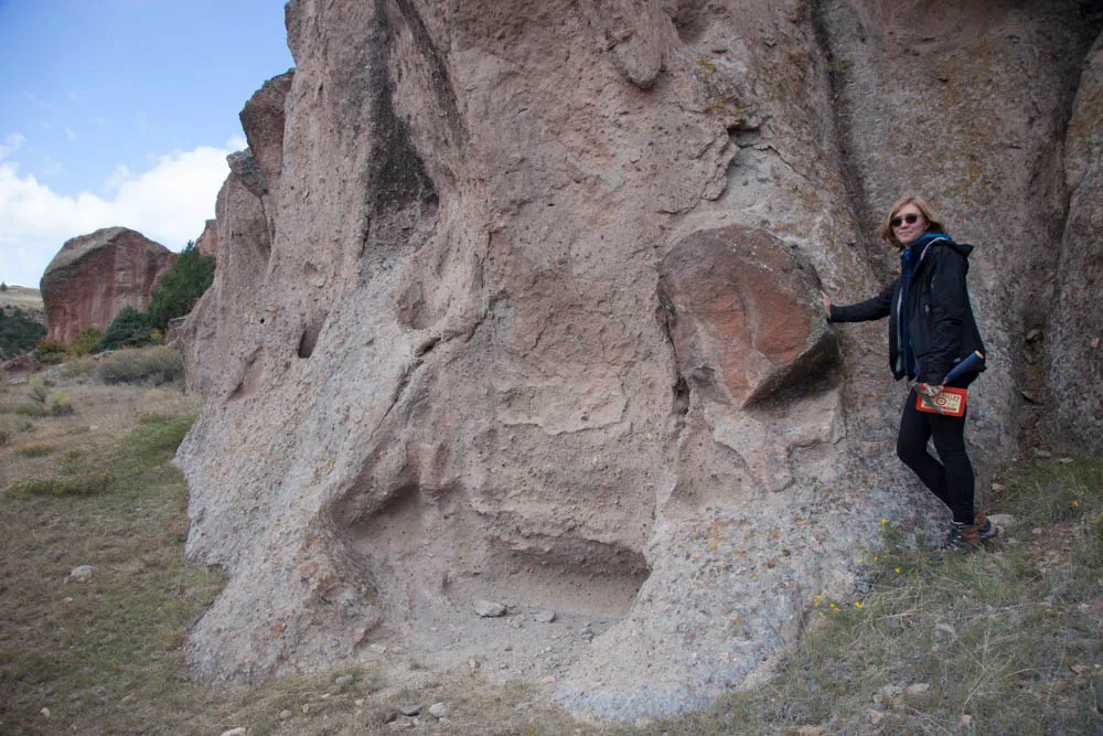 Geologist examining rock formation in the field