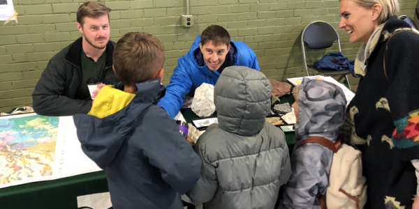 USGS geoscientists displaying rocks at 2024 STEM event